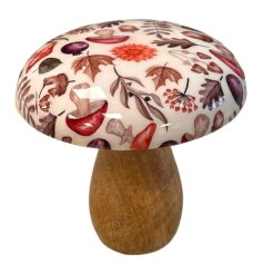 A captivating mushroom crafted from mango wood, featuring a glazed top with an enchanting autumnal pattern