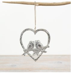 An endearing metal heart with two nestled birds in the center, adding a delightful touch of whimsy to enhance any space.