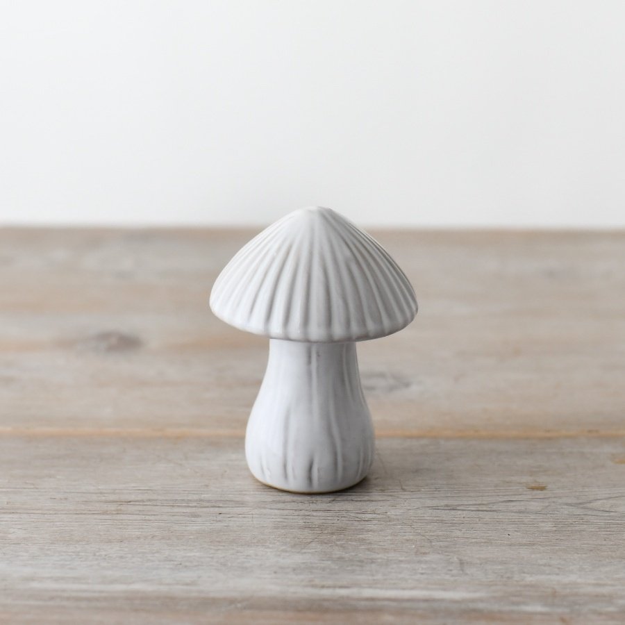 A delightful ceramic mushroom ornament with whimsical reactive glazing