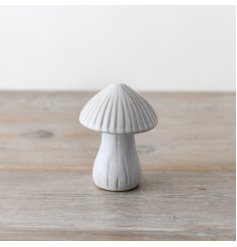 A delightful ceramic mushroom ornament with whimsical reactive glazing