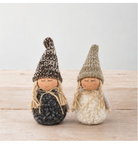 A collection of two charming fabric dolls in black and white, featuring sherpa bodies and knitted hats.