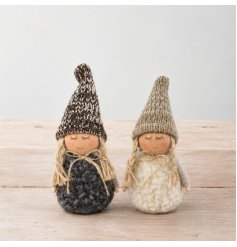 A collection of two charming fabric dolls in black and white, featuring sherpa bodies and knitted hats.