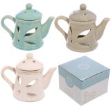 A shabby chic oil burner in the shape of a teapot in 3 assorted designs. 