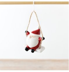 An adorable little ceramic santa on a swing, complete with a jute string to hang.