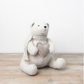 "The charming fabric teddy bear is perfect for adding a wintry touch to your Christmas decor."