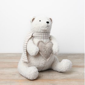 A charming sherpa polar bear plush ornament, adorned with a neutral scarf and clutching a heart.