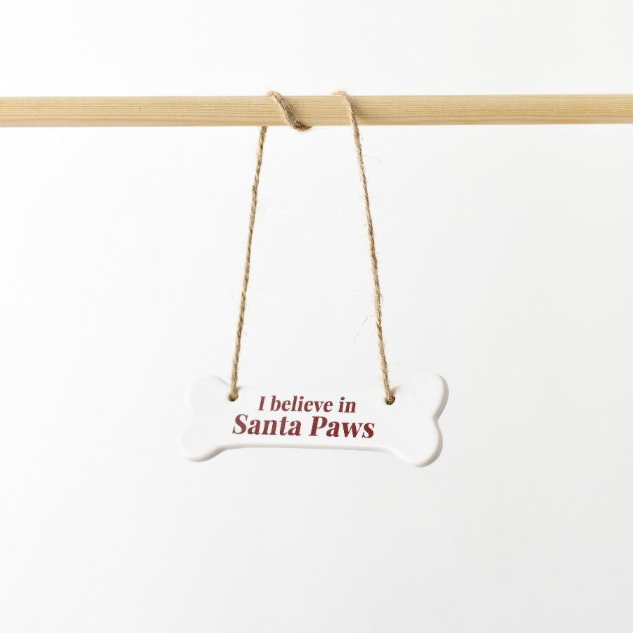 A delightful ceramic ornament crafted in the shape of a bone, showcasing the message 