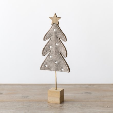 A serene and calm felt Christmas tree decoration stood on a wooden base. 