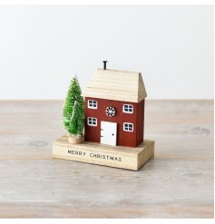 A rustic christmas house with merry christmas and trees