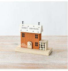 A charming wooden house decoration with painted features and 3D elements. 