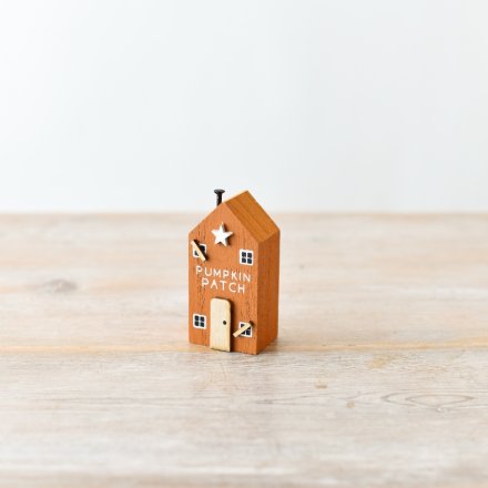 A must have miniature wooden house with pumpkin patch slogan and charming 3D spooky details.