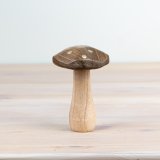 Add whimsical charm with this rustic mushroom decoration.