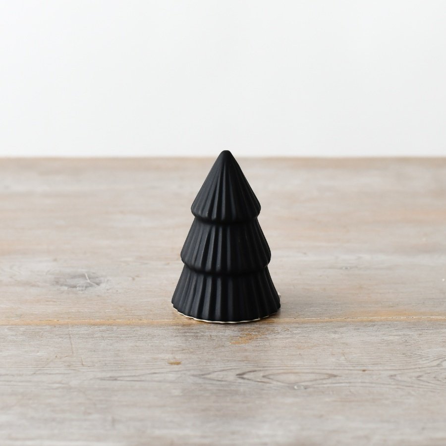 Add a touch of sophistication with our petite tree figurine, crafted in a sleek matte black finish.