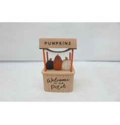 A cute resin pumpkin patch stand featuring 3 coloured pumpkins.