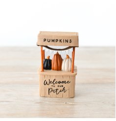 A cute resin pumpkin patch stand featuring 3 coloured pumpkins.