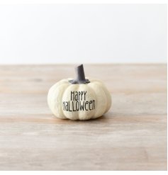 An adorable white pumpkin decoration featuring the phrase 'Happy Halloween' engraved in black text.