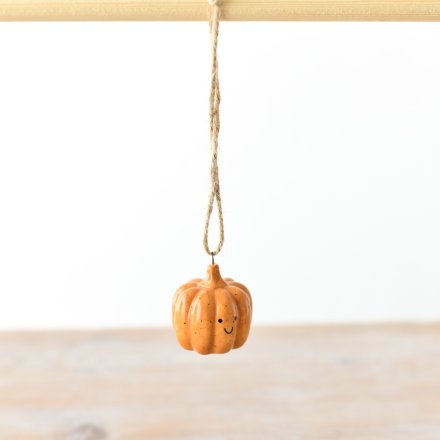 A small and adorable orange pumpkin hanger with a cute smiley face