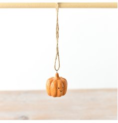 A small and adorable orange pumpkin hanger with a cute smiley face