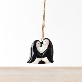 An enchanting duo of ceramic penguins, complemented by a natural jute string for effortless suspension.