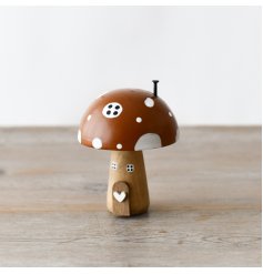 A charming and beautifully detailed wooden mushroom house with painted features and 3D details. 