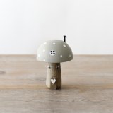 A chic wooden mushroom ornament with charming painted details. 