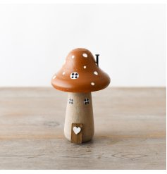 A wonderful and whimsical wooden mushroom house with hand painted details and 3D features. 