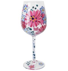 A beautiful hand painted pink Gerbera wine glass, perfect for adding a touch of elegance to any kitchen