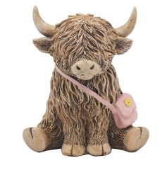 A charming resin sculpture of a Highland cow carrying a delightful pink crossbody bag.