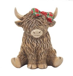 An adorable highland cow ornament with a cute tartan bow