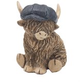 An adorable little highland cow ornament complete with a denim blue flat cap