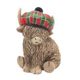 A stunningly adorable highland cow ornament featuring a tartan hat