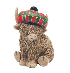 A stunningly adorable highland cow ornament featuring a tartan hat