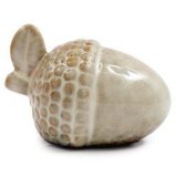 A ceramic acorn decoration with neutral tones and textured finish. 