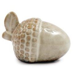 A ceramic acorn decoration with neutral tones and textured finish. 