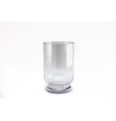 A stylish hurricane vase with a bubble effect detail.