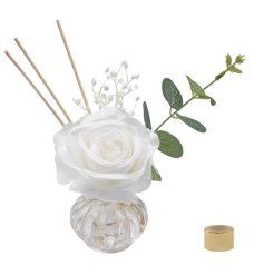 A gorgeous glass reef diffuser featuring a single faux rose, eucalyptus stem and gypsophila with a luxu suede fragrance.