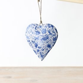 A folk art inspired hanging heart decoration featuring a jumping hare, fauna and flora. 