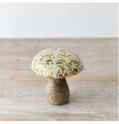 A stylish and chic wooden mushroom featuring a stunning glazed top adorned with gorgeous a autumnal pattern
