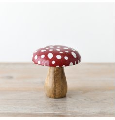 A woodland mushroom ornament with a classic red and white polka dot design. 
