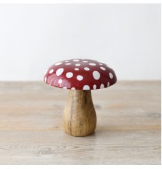 A charming red and white polka dot mushroom ornament. With a glossy enamel cap and irregular dotty design.