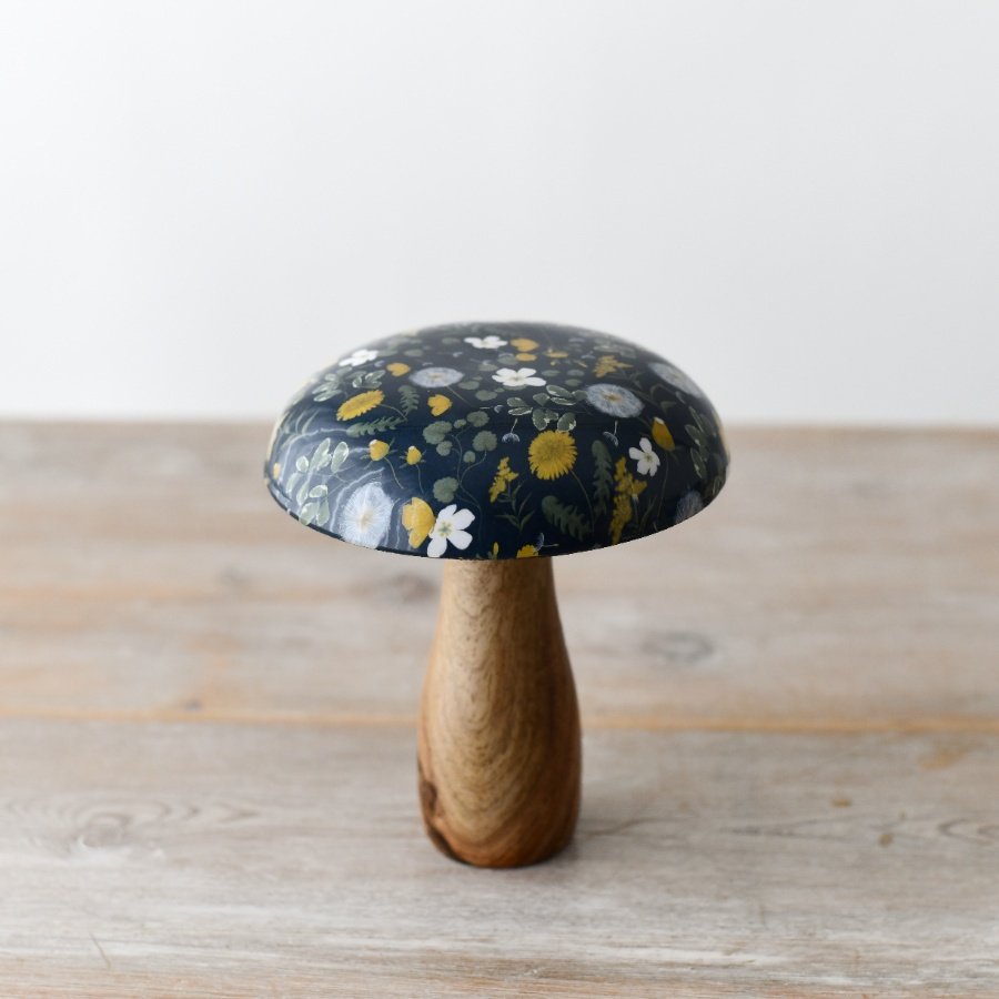 A chic and quaint wooden mushroom decoration with an floral enamel top.