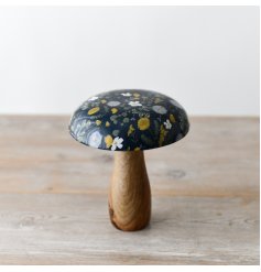 A floral wooden mushroom ornament with a glazed top. 