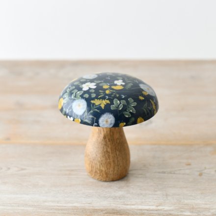 A natural mushroom ornament made from wood, decorated with an enamel springtime pattern. 