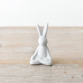 A contemporary sitting rabbit decoration with a textured, white finish. 