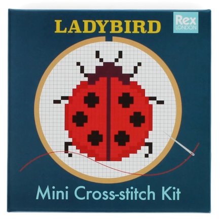 A cross-stitch kit showcasing a ladybird design, ideal for instructing young cross-stitch enthusiasts. 