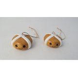 An adorable hot cross bun hanging decoration with a smiley face.