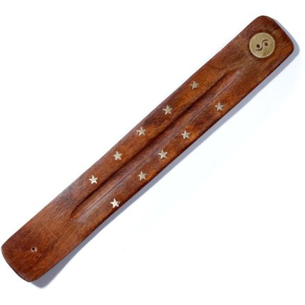 This dark brown incense stick tray has detailed star features and a Ying Yang symbol at one end.