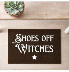 Shoes off witches! A black doormat featuring witchey slang and a star decal.