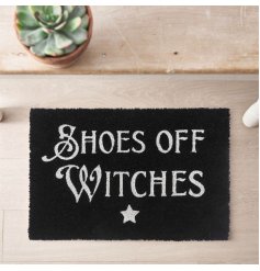 Shoes off witches! A black doormat featuring witchey slang and a star decal.