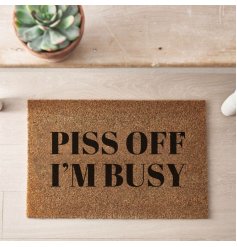 A stylish coir doormat with 'Piss off I'm busy' printed text in black. 
